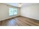 Bedroom features wooden floors, a ceiling fan and a large window at 167 Bell Tower Xing W, Poinciana, FL 34759