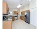 Bright kitchen with stainless steel appliances, granite countertops, and tile flooring at 167 Bell Tower Xing W, Poinciana, FL 34759