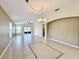 Spacious living room area with large windows and sliding doors that provide ample natural light and tile flooring at 167 Bell Tower Xing W, Poinciana, FL 34759