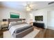 Spacious main bedroom with neutral walls, wood floors, ceiling fan and ensuite bathroom at 167 Bell Tower Xing W, Poinciana, FL 34759