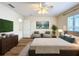 Main bedroom with a king bed, wood floors, a ceiling fan and a TV at 167 Bell Tower Xing W, Poinciana, FL 34759