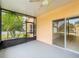 Relaxing screened patio with a ceiling fan and beautiful view of the landscaped yard at 167 Bell Tower Xing W, Poinciana, FL 34759