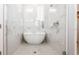 Spa-like bathroom with a freestanding soaking tub and marble tile at 1735 Oak Blossom Dr, Davenport, FL 33837