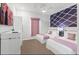 Bedroom with two beds, stylish decor, and a large TV at 1735 Oak Blossom Dr, Davenport, FL 33837