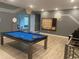 Game room features a pool table, gaming station, and wall-mounted games at 1735 Oak Blossom Dr, Davenport, FL 33837