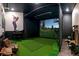 Home golf simulator with large screen and putting green at 1735 Oak Blossom Dr, Davenport, FL 33837