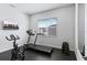 Bright home gym with a treadmill, stationary bike, and free weights at 1735 Oak Blossom Dr, Davenport, FL 33837