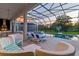 Relaxing pool area with lounge chairs and covered patio at 1735 Oak Blossom Dr, Davenport, FL 33837