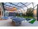 Covered patio with pool, ping pong, and lounge chairs at 1735 Oak Blossom Dr, Davenport, FL 33837