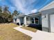 Modern home with a covered front porch and walkway leading to the front door at 1317 Hillsborough Ct, Kissimmee, FL 34759