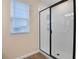 Shower with glass enclosure and white tile at 2918 Sharp Rd, Kissimmee, FL 34744