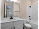 Bathroom with white vanity, tub shower combo, and tile floor at 2918 Sharp Rd, Kissimmee, FL 34744