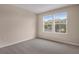 Bedroom with neutral walls, grey carpet, and two windows at 2918 Sharp Rd, Kissimmee, FL 34744