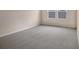 Bright bedroom with neutral walls and grey carpet at 2918 Sharp Rd, Kissimmee, FL 34744