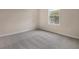 Bedroom with neutral walls, grey carpet, and one window at 2918 Sharp Rd, Kissimmee, FL 34744