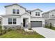 Two-story house with gray garage door and stone accents at 2918 Sharp Rd, Kissimmee, FL 34744