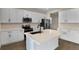 Modern kitchen with white cabinets, island, and stainless steel appliances at 2918 Sharp Rd, Kissimmee, FL 34744