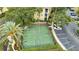 Aerial view of a community basketball court with lush landscaping, parking, and a nearby building at 1100 Lake Shadow Cir # 2101, Maitland, FL 32751
