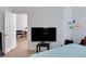 Bedroom featuring a television, closet, and open doorway leading to an adjacent room at 1100 Lake Shadow Cir # 2101, Maitland, FL 32751
