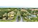 Inviting community entrance featuring lush landscaping, palm trees, and well-maintained buildings with tile roofs at 1100 Lake Shadow Cir # 2101, Maitland, FL 32751