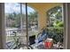 Screened-in patio with outdoor seating, bicycles, and a view of the parking area and surrounding landscape at 1100 Lake Shadow Cir # 2101, Maitland, FL 32751