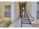 Exterior building shot of a stairwell to apartments with black handrails and painted stairs at 1100 Lake Shadow Cir # 2101, Maitland, FL 32751
