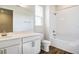 Bright bathroom with a shower-tub combo, single sink, and wood-look tile floors at 636 Hennepin Loop, Lake Wales, FL 33898