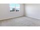 Comfortable bedroom featuring neutral carpet and one large window at 636 Hennepin Loop, Lake Wales, FL 33898