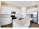 Bright, modern kitchen with stainless steel appliances, white cabinets, and large island at 636 Hennepin Loop, Lake Wales, FL 33898