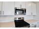 Close up of the kitchen featuring stainless steel microwave and black stovetop at 636 Hennepin Loop, Lake Wales, FL 33898