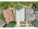 An aerial view of a single Gathering home on a tree-lined street at 1404 Longville Cir, Tavares, FL 32778