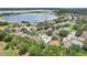 A serene aerial view of a neighborhood near a beautiful lake at 1404 Longville Cir, Tavares, FL 32778