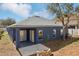 Exterior back view of a home featuring a patio and lush backyard at 1404 Longville Cir, Tavares, FL 32778