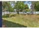 A spacious backyard featuring a hammock and bordered by a white privacy fence at 1404 Longville Cir, Tavares, FL 32778