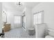 Chic bathroom showcasing a modern vanity, patterned floor tiles, and glass-enclosed shower at 1404 Longville Cir, Tavares, FL 32778