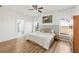 Bright bedroom featuring a ceiling fan, wood-look floors, and two windows at 1404 Longville Cir, Tavares, FL 32778