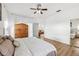 Cozy bedroom with a ceiling fan, wood-look floors, and ample natural light at 1404 Longville Cir, Tavares, FL 32778