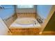 Relaxing bathroom with a large garden tub and tile surround at 14642 Yellow Butterfly Rd, Windermere, FL 34786