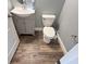 Clean bathroom with gray vanity and wood-look floors at 14642 Yellow Butterfly Rd, Windermere, FL 34786