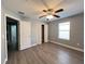 Well-lit bedroom with wood-look floors and ample closet space at 14642 Yellow Butterfly Rd, Windermere, FL 34786