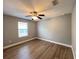 Bright bedroom featuring wood-look floors and a ceiling fan at 14642 Yellow Butterfly Rd, Windermere, FL 34786