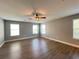 Large bedroom with wood-look floors, three windows, and a ceiling fan at 14642 Yellow Butterfly Rd, Windermere, FL 34786