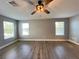 Spacious bedroom with wood-look flooring and ceiling fan at 14642 Yellow Butterfly Rd, Windermere, FL 34786