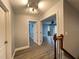 Upstairs hallway with wood-look floors and access to bedrooms at 14642 Yellow Butterfly Rd, Windermere, FL 34786