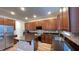 Modern kitchen with granite countertops and wood cabinets at 14642 Yellow Butterfly Rd, Windermere, FL 34786