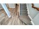 Modern staircase with wood-look flooring and railing at 14642 Yellow Butterfly Rd, Windermere, FL 34786