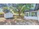 Spacious backyard featuring a shed, mature tree, and screened-in porch for relaxing at 2220 Crystal Grove Ln, Lakeland, FL 33801