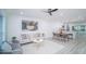 Bright living room with modern decor, sleek ceiling fan, and wood-look flooring, flowing into dining area at 2220 Crystal Grove Ln, Lakeland, FL 33801