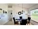 Dining area with glass table, four chairs, and view to hallway at 325 Ashley Loop, Davenport, FL 33837