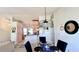 Bright dining room with glass table and four chairs, features a modern light fixture at 325 Ashley Loop, Davenport, FL 33837